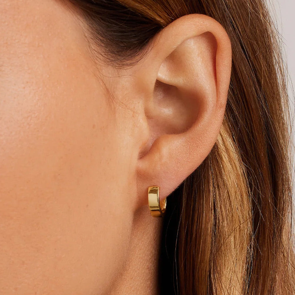 gorjana Rose Huggies in gold, worn on ear