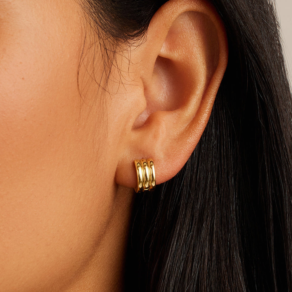 gorjana Reed Huggies in gold, worn on ear