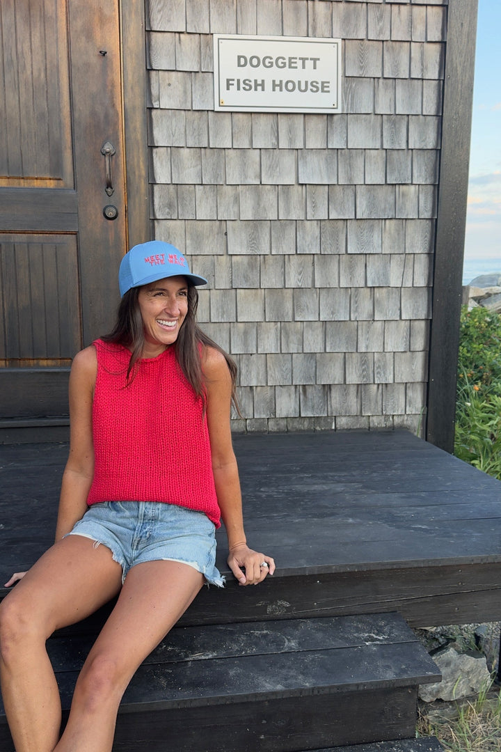 Meet Me At The Wall light blue trucker hat on model at Doggett Fish House