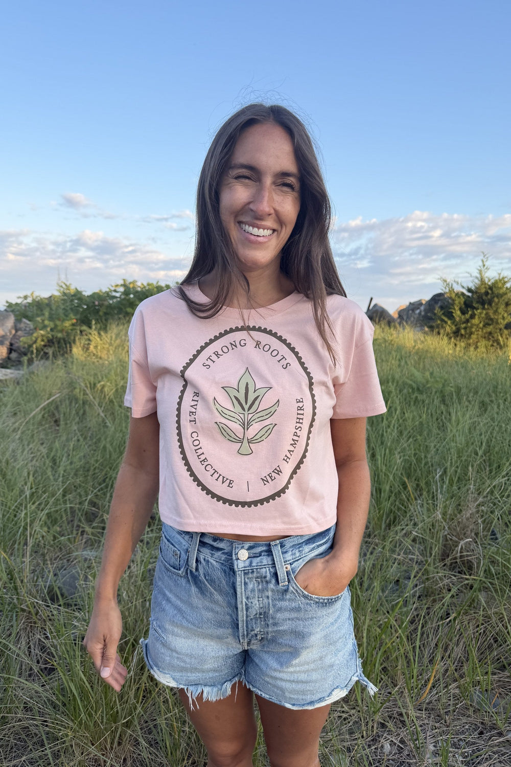 Strong Roots peach crop tee front graphic on smiling model