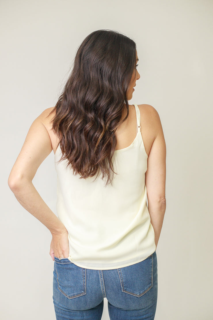 Back view of woman wearing mid rise skinny jeans in medium wash 