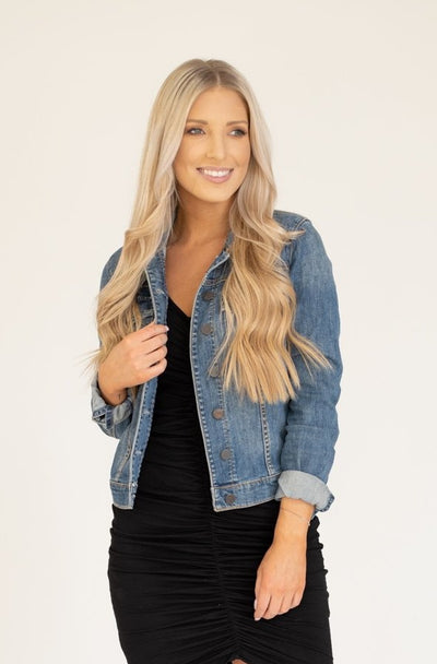 Denim jacket with buttons in a medium wash and a structured but comfortable fit