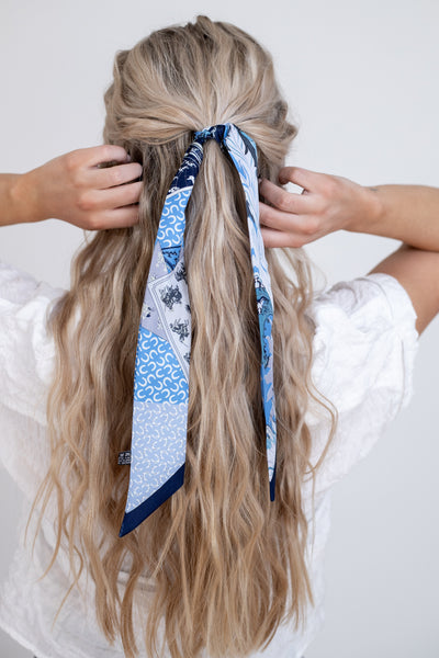 Blue mini scarf with white feather pattern can be tied in the hair