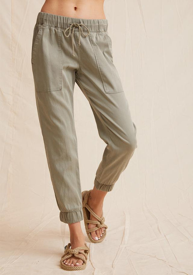 Everyday jogger in muted army green color with tie waist, cuffed bottoms, and pockets
